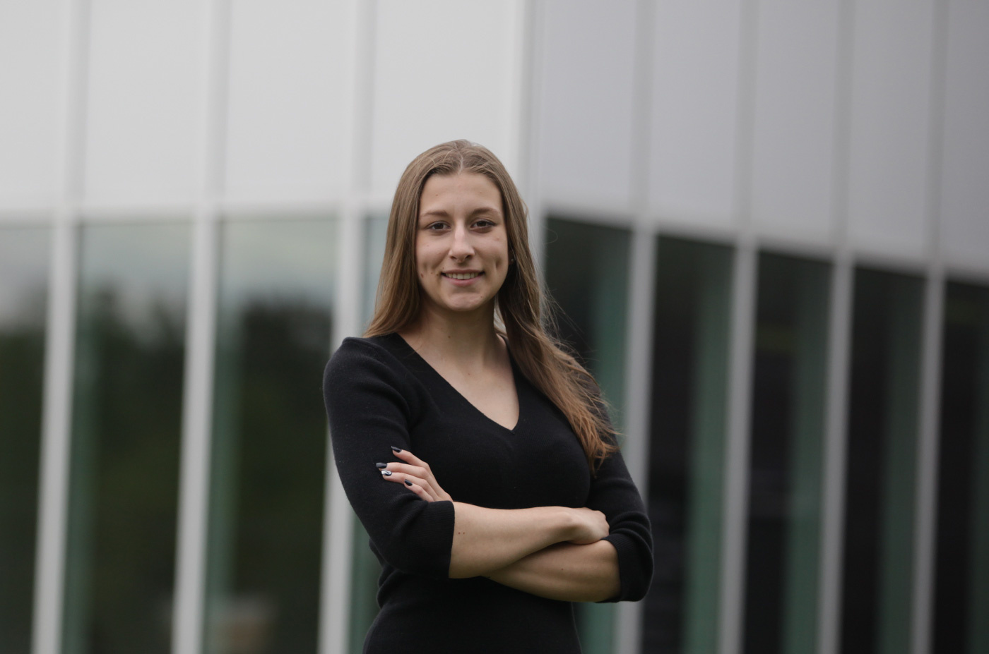 Making an impact is about more than leaving a mark. It’s about touching and changing lives in a dramatic way. Lisa Ludwig smiling in front of a building