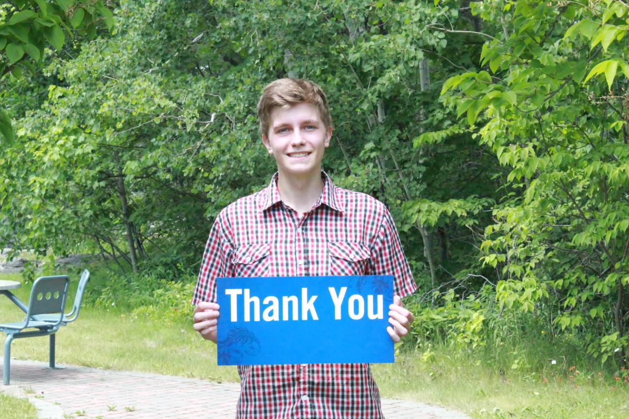 National Philanthropy Day 2024 Student holding thank you sign