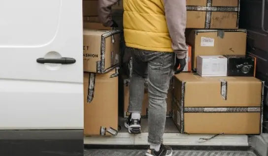 A man going into a van to grab some boxes