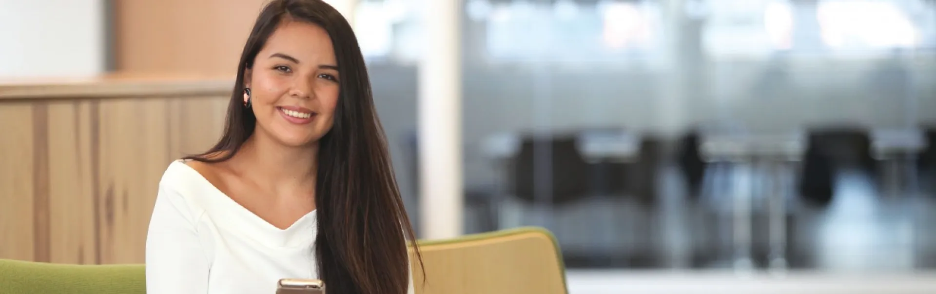 A student is smiling while seated