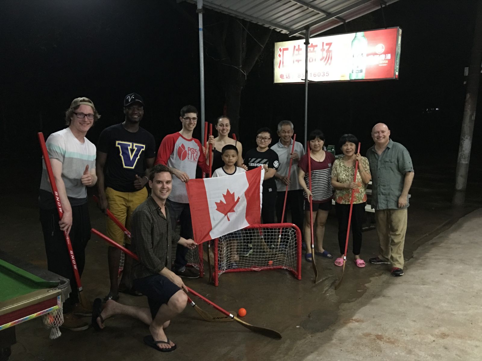 A group of people holding hockey equipment 