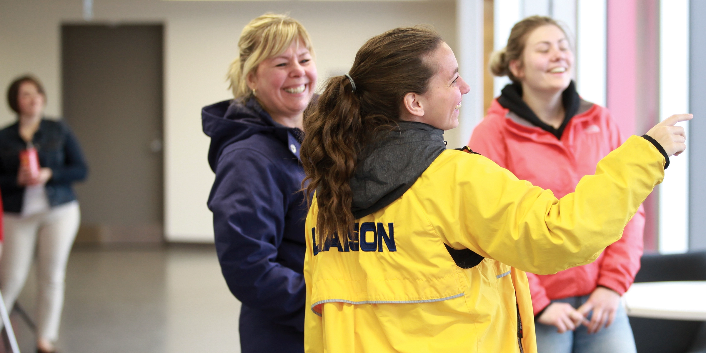 A Laurentian University recruitment team member giving a campus tour and smiling.