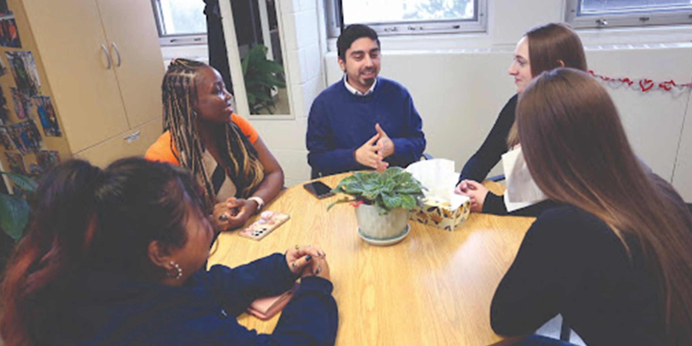 Students sitting around a table having a meeting
