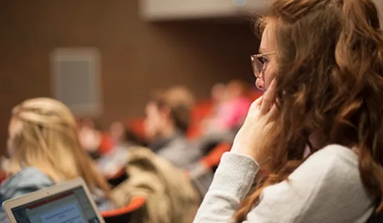 A student sits in a lecture in the Fraser Auditorium.