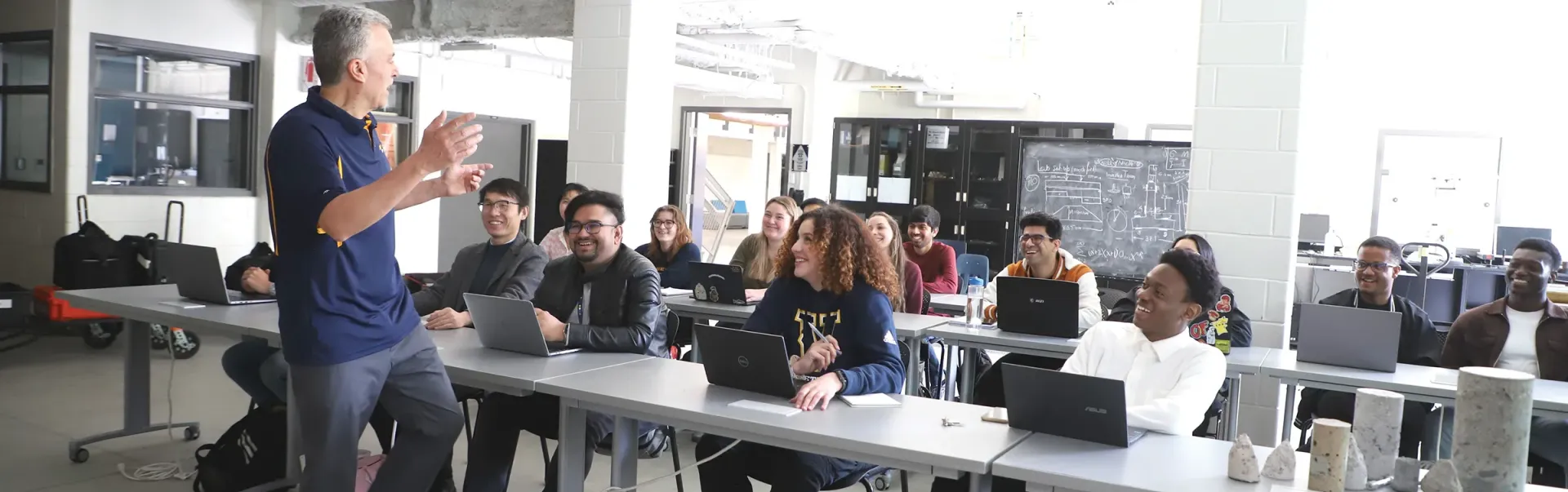 A professor teaching a lecture to a classroom of students.